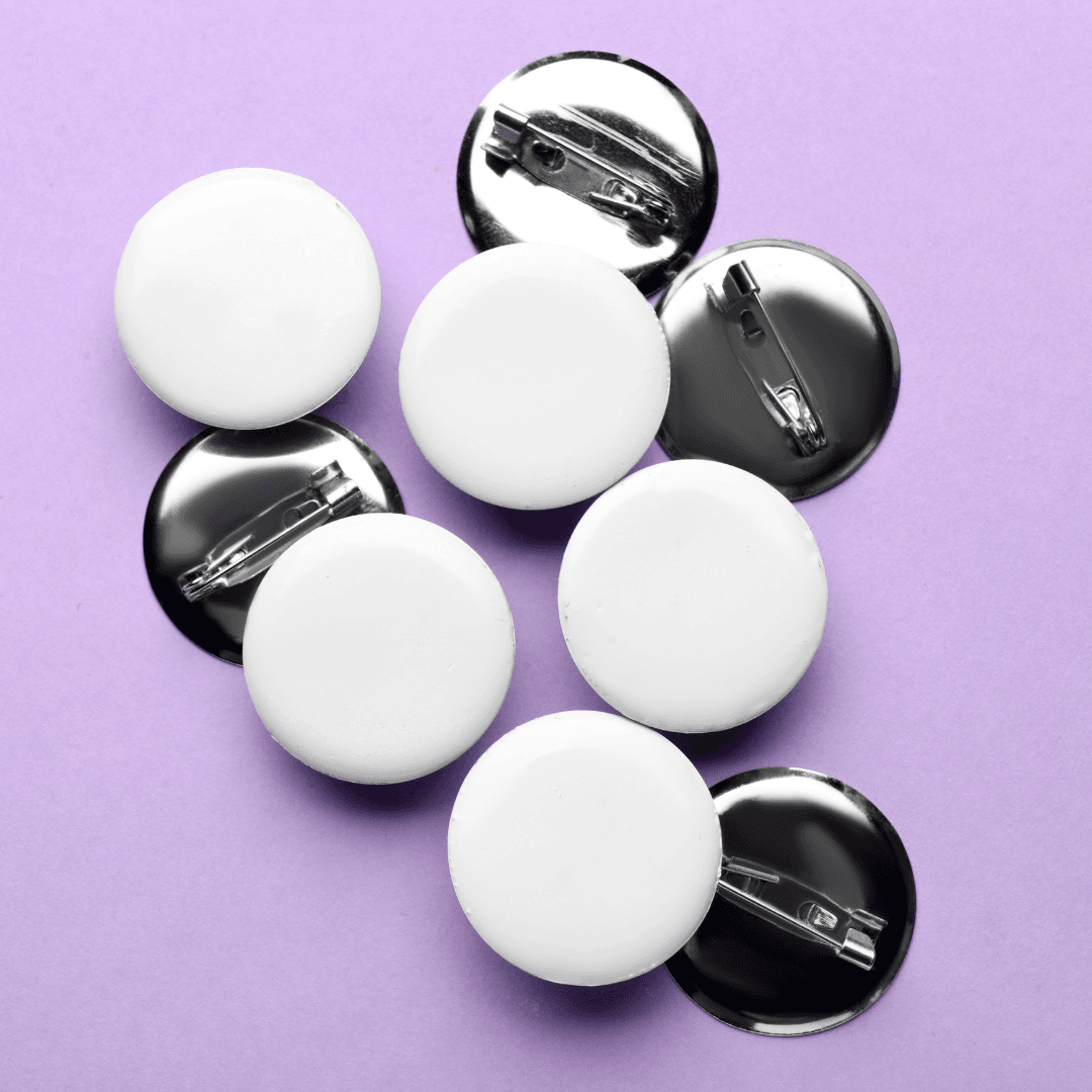 some black pinback buttons on a purple backgrouns